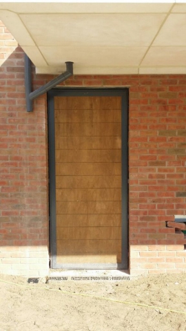 INDUSTRIAL STEEL SINGLE DOOR WITH WOOD FACIA FABRICATED TO LPS1175 SR2 AND PAS24 STANDARD. PRODUCED AND INSTALLED BY PREMIER SECURITY CONSULTANTS LTD.