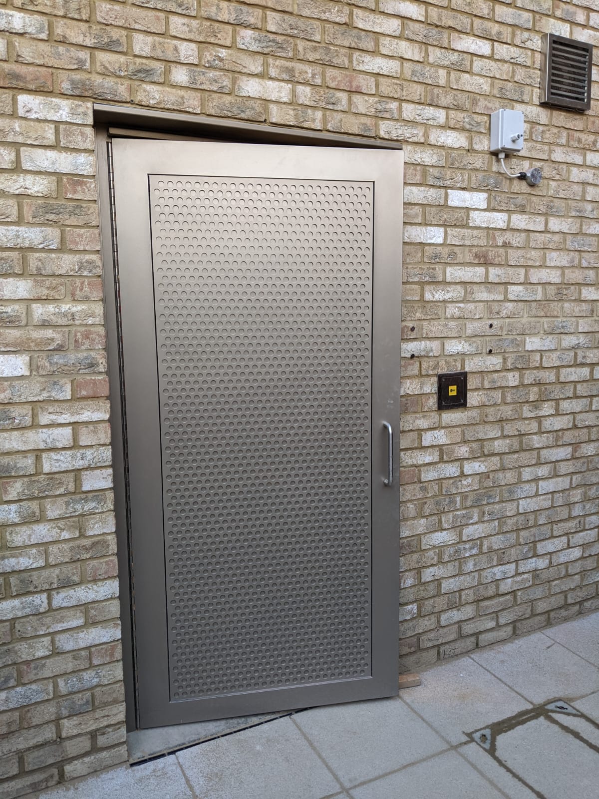 Industrial steel door incorporating perforated design achieving LPS1175 SR2 rating and Secured by Design accreditation.