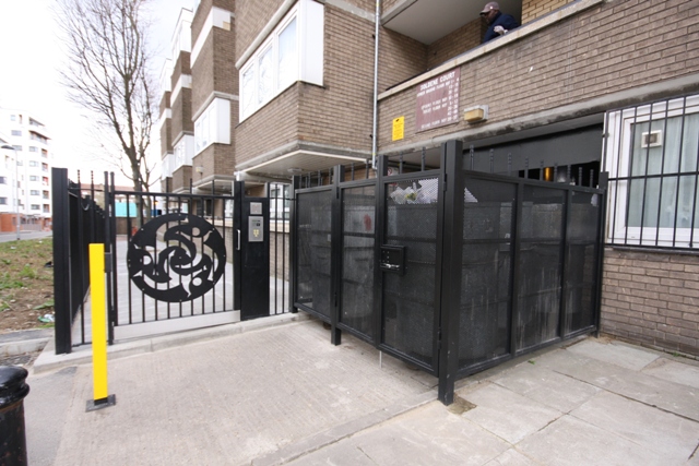 STEEL FENCED BIN STORAGE AREA AND DECORATIVE STEEL GATE FABRICATED AND INSTALLED BY PREMIER SECURITY CONSULTANTS THE HOME OF SECURED BY DESIGN
